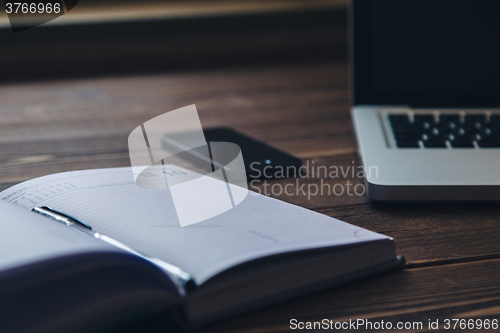 Image of Laptop and diary on the desk