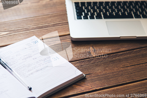 Image of Laptop and diary on the desk