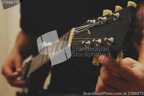 Image of Man playing on guitar