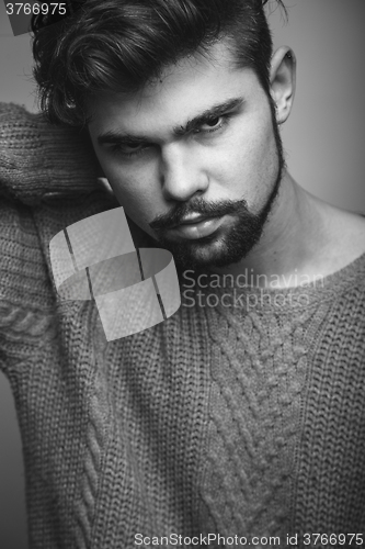 Image of Black and white portrait of a young man in gray pullover