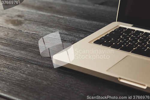 Image of Laptop on modern wooden desk 