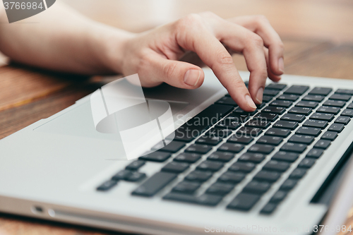 Image of Close-up shot of laptop on old wooden desk