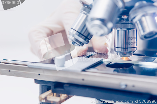 Image of Scientist hands with microscope