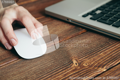 Image of Close-up shot of laptop on old wooden desk