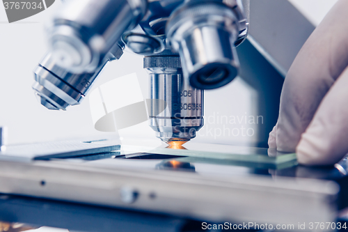 Image of Scientist hands with microscope