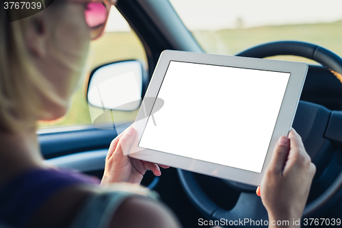 Image of Woman using tablet pc in the car