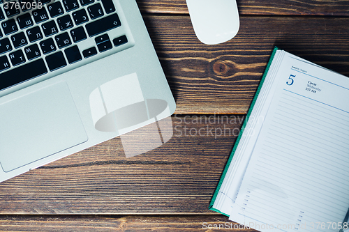 Image of Laptop and diary on the desk