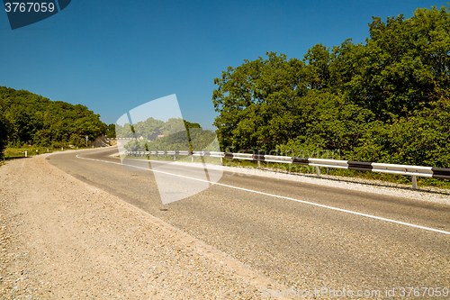 Image of Curved asphalt road in mountains 