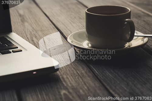 Image of Laptop on modern wooden desk 