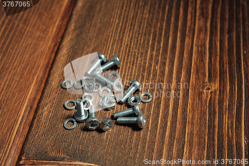 Image of Screws on the wooden background