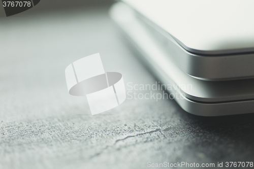 Image of Two closed laptops on modern wooden desk 