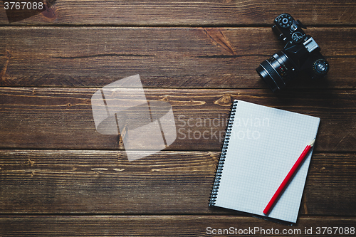 Image of notebook and vintage camera on the desk