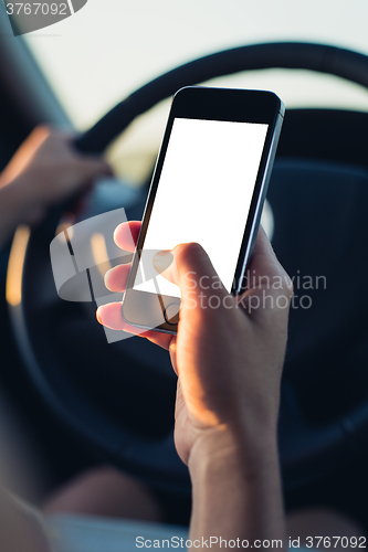 Image of Woman using phone in the car