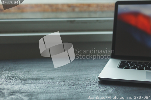 Image of Laptop on modern wooden desk 