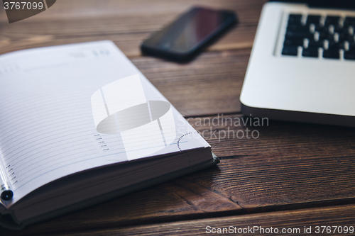 Image of Laptop and diary on the desk