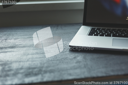 Image of Laptop on modern wooden desk 