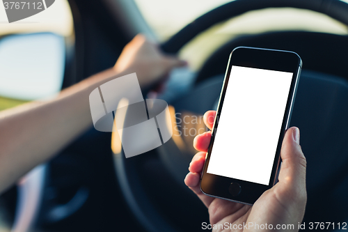 Image of Woman using phone in the car