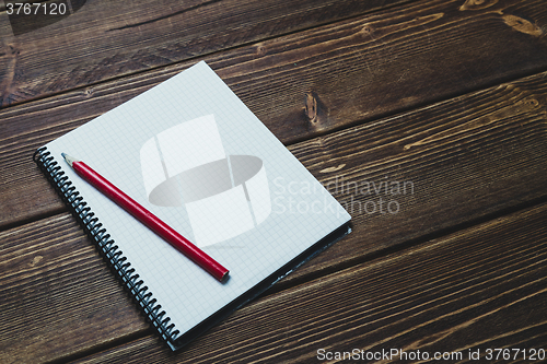 Image of notebook with pen and coffee  on old  wooden table