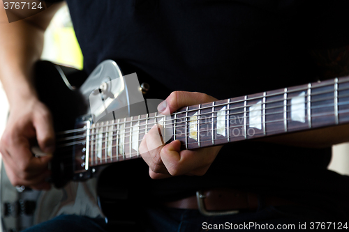 Image of Man playing on guitar