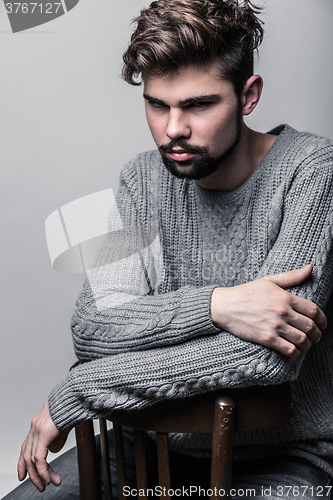 Image of Portrait of a young man in gray pullover