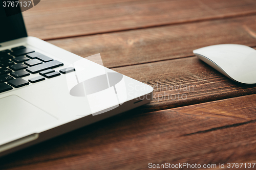 Image of Close-up shot of laptop on old wooden desk