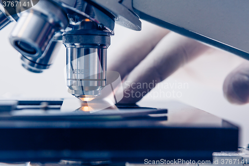 Image of Scientist hands with microscope