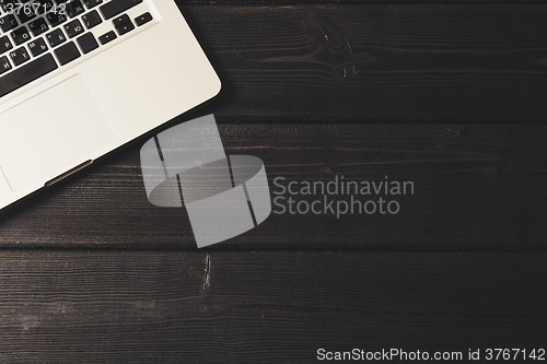 Image of Laptop on modern wooden desk 