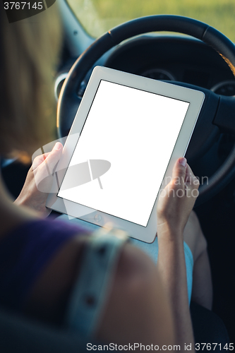 Image of Woman using tablet pc in the car