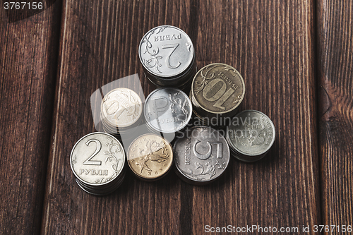 Image of Top view coins on old wooden desk with copy space on top.