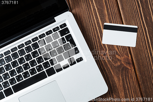 Image of Laptop and credit card on the desk