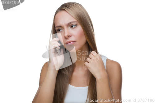 Image of Sad woman talking on phone