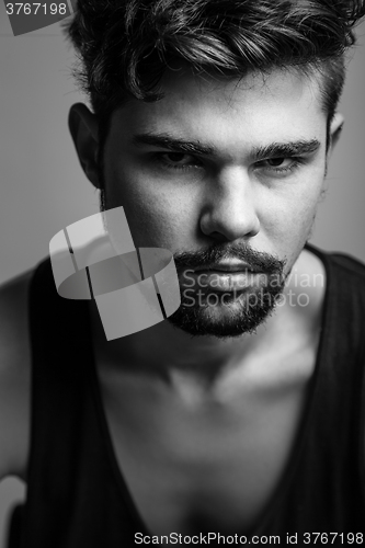 Image of Black and white portrait of a young man in a black t-shirt