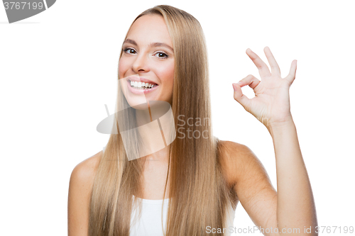 Image of Young woman shows gesture ok on white background