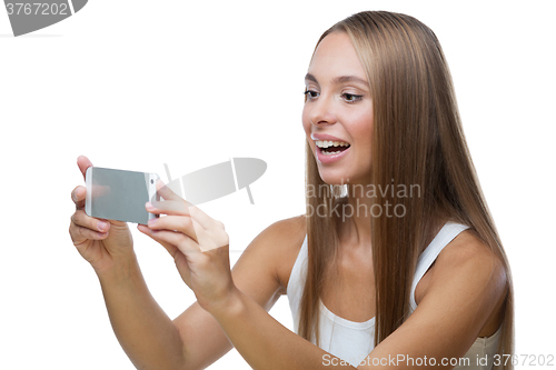 Image of Woman taking pictures of something on the phone