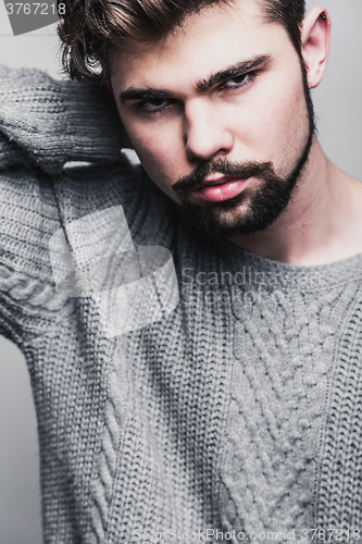 Image of Portrait of a young man in gray pullover