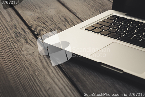 Image of Laptop on modern wooden desk 