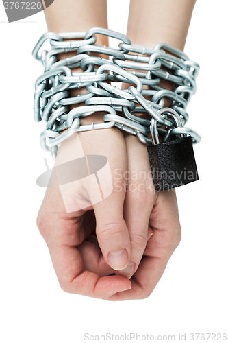 Image of Social theme: hands tied a metal chain on a white background