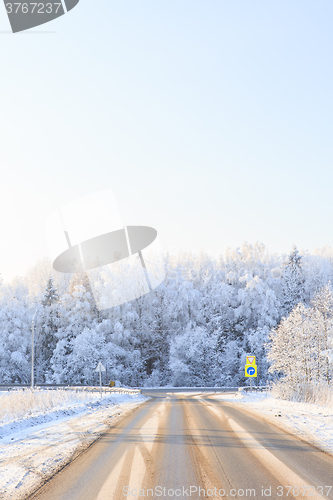 Image of Winter road through snowy fields and forests