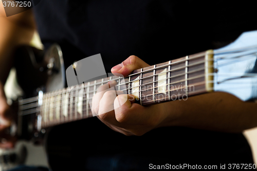 Image of Man playing on guitar