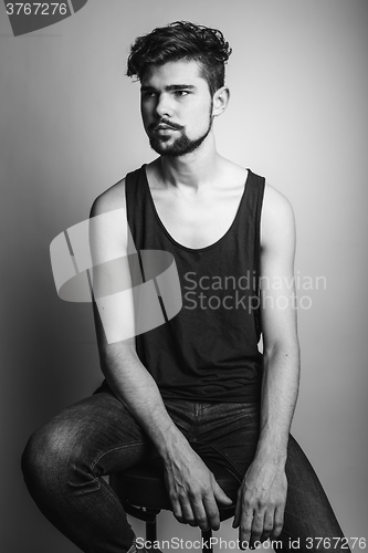 Image of Black and white portrait of a young man in a black t-shirt