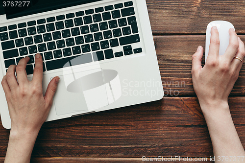 Image of Close-up shot of laptop on old wooden desk