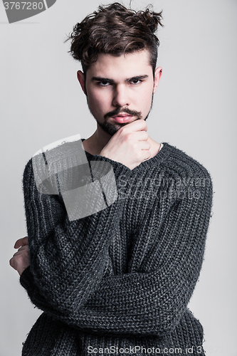 Image of Portrait of a young man in gray pullover