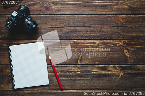 Image of notebook and vintage camera on the desk