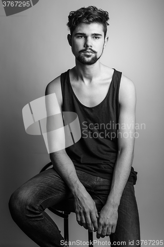 Image of Black and white portrait of a young man in a black t-shirt