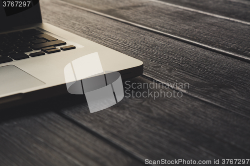 Image of Laptop on modern wooden desk 