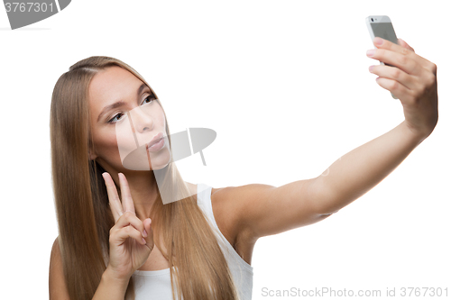 Image of beautiful woman make selfie on white background