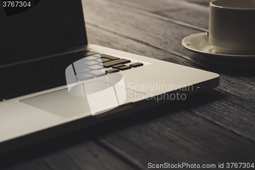 Image of Laptop on modern wooden desk 