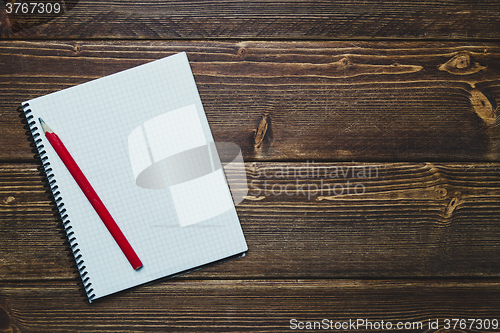 Image of notebook with pen and coffee  on old  wooden table