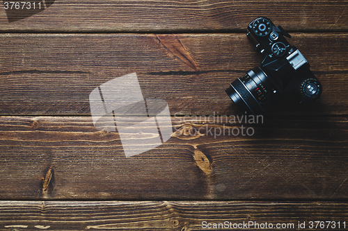 Image of Old camera on wooden table