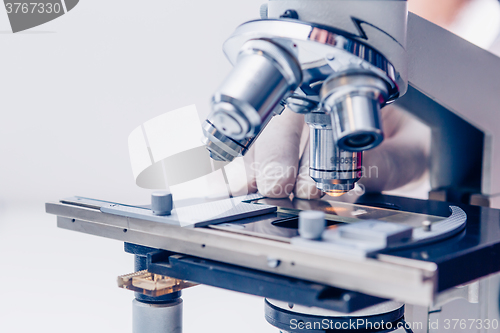 Image of Scientist hands with microscope